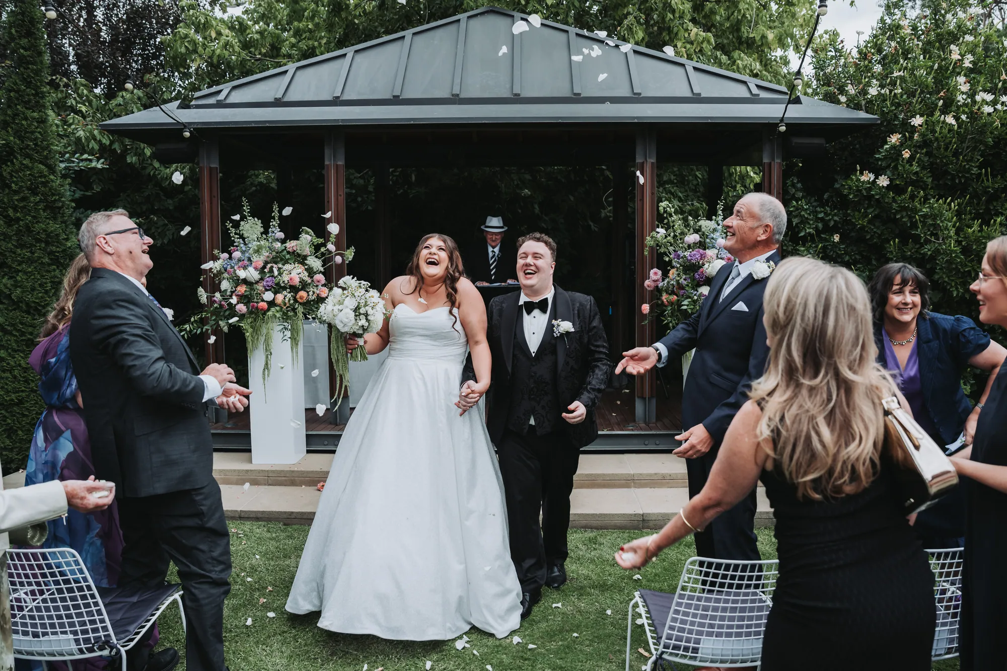 Confetti and laughter as Russell and Holly leave the ceremony