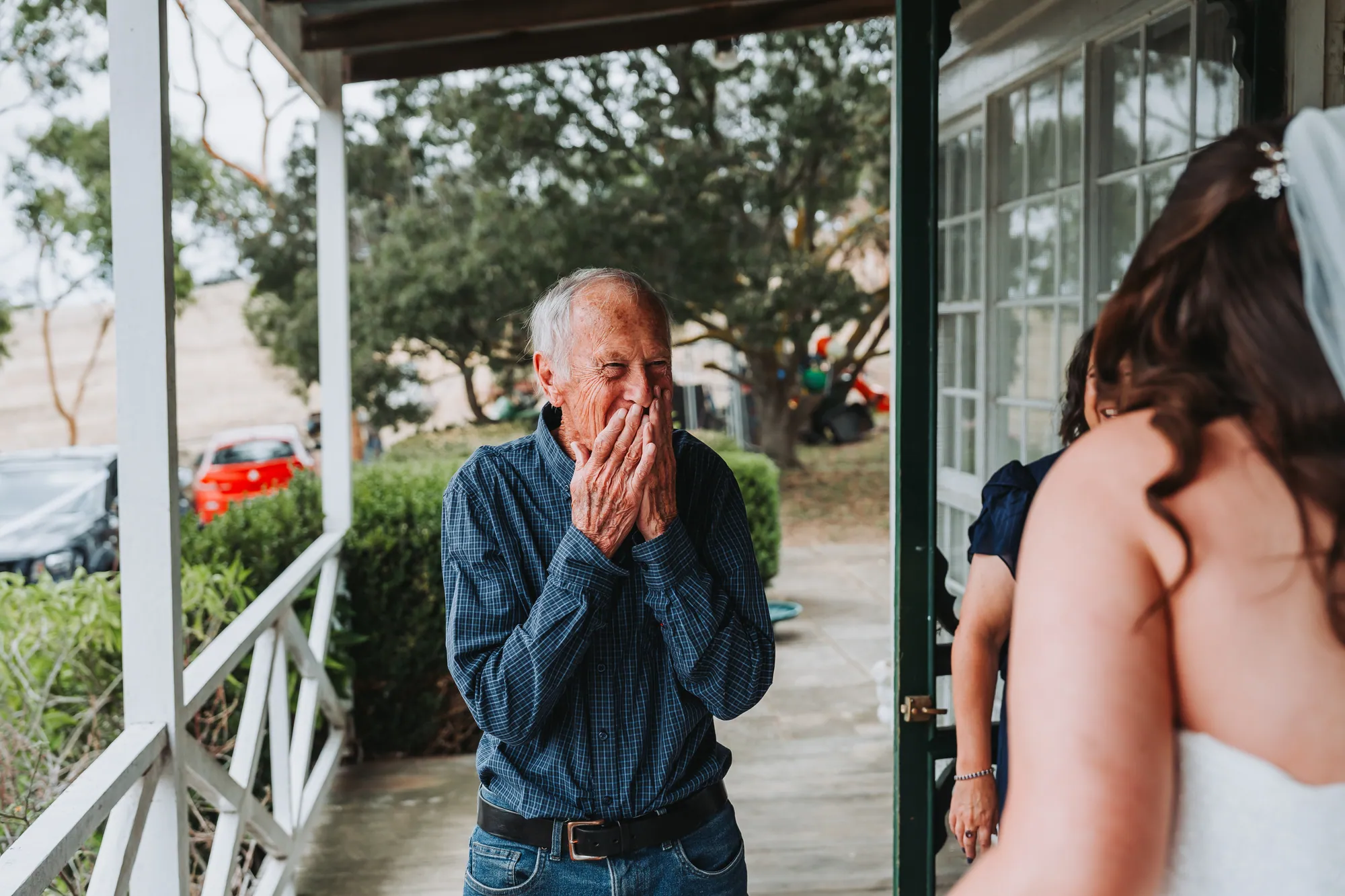 A father catching his breath as the bride steps out